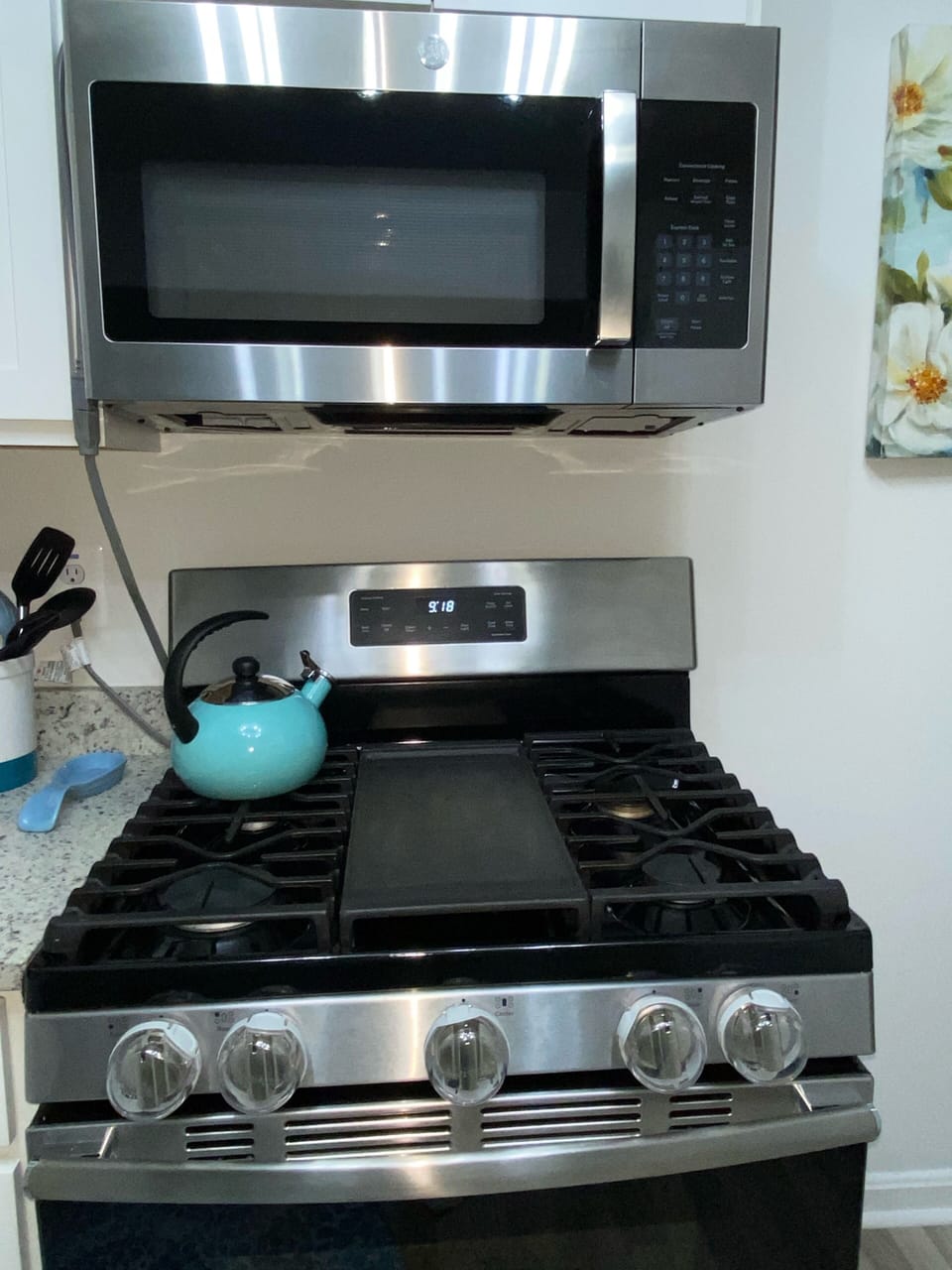 Gas stovetop 5 burner with child locks, oven, warmer drawer, and microwave.