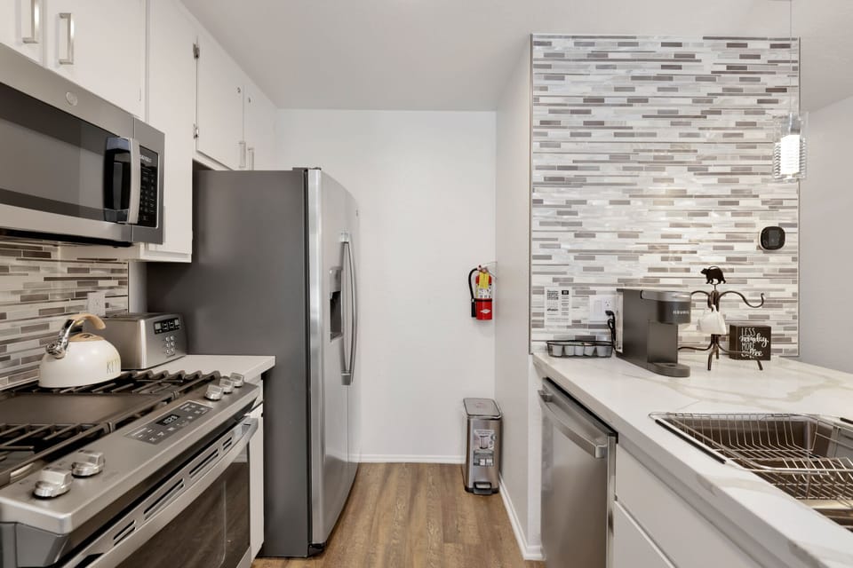 Fully equipped cabin kitchen with ample cabinetry, stove, fridge, microwave, and coffee maker—perfect for cooking meals, morning coffee, and feeling right at home on your stay.