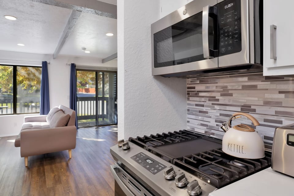 Fully equipped cabin kitchen with ample cabinetry, stove, fridge, microwave, and coffee maker—perfect for cooking meals, morning coffee, and feeling right at home on your stay.