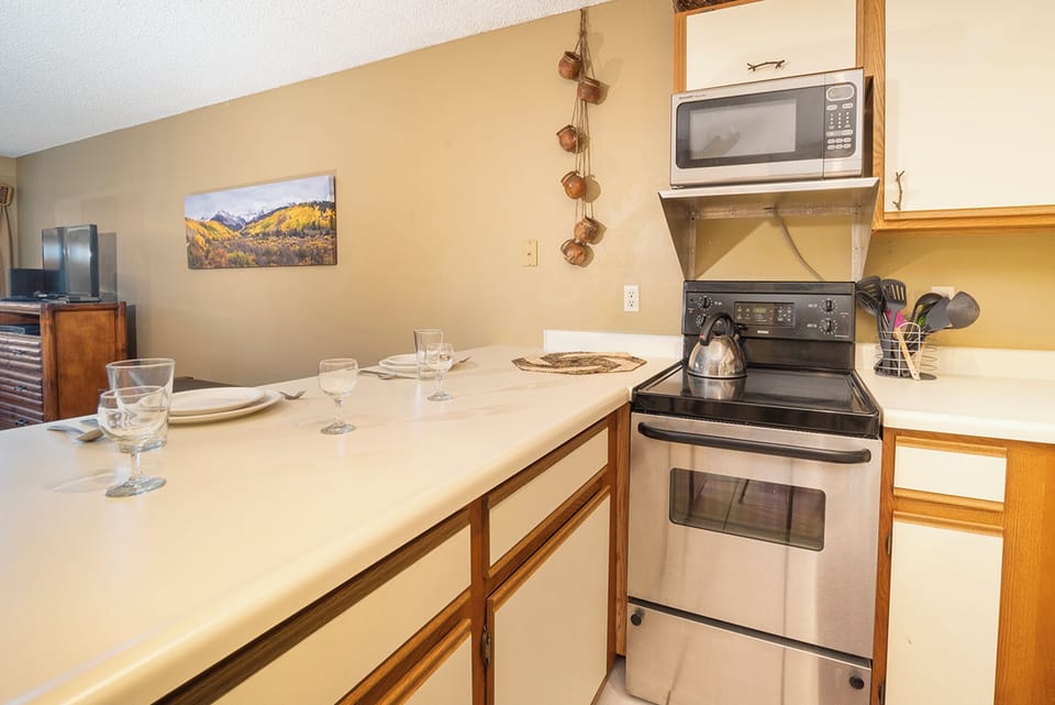 Your fully equipped kitchen invites you to whip up memorable meals with stainless appliances and cozy mountain views.