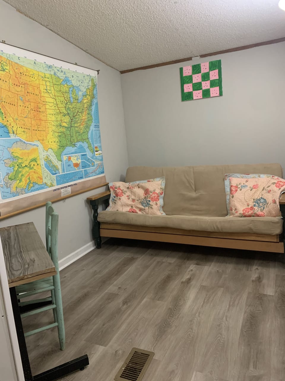 Office space with homemade desk and futon.
