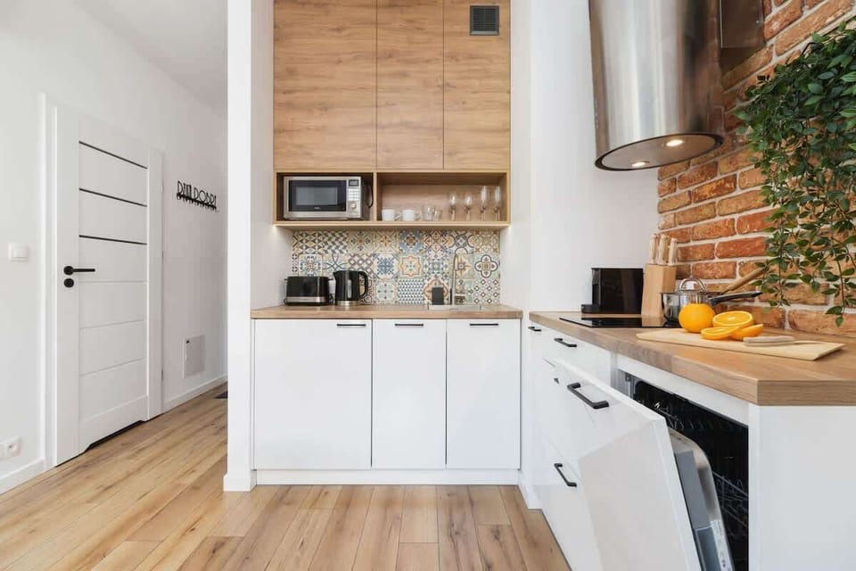 Fully equipped kitchenette with a fridge, kettle, induction hob, toaster, coffee machine, microwave and dishwasher.