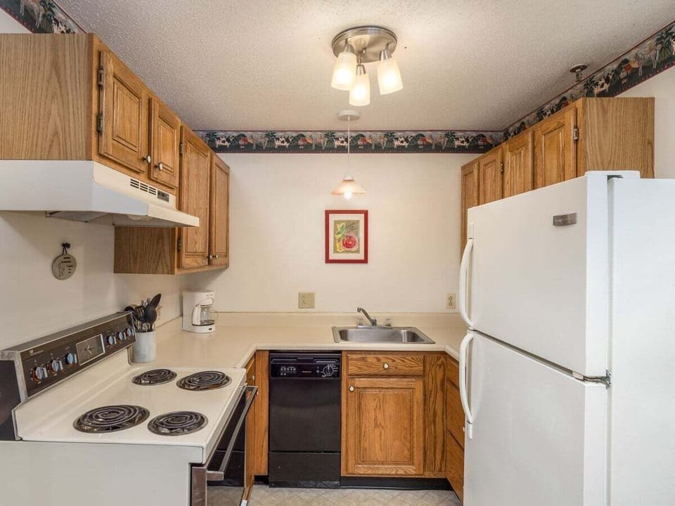 kitchen is stocked with dishes, glassware, pots and pans