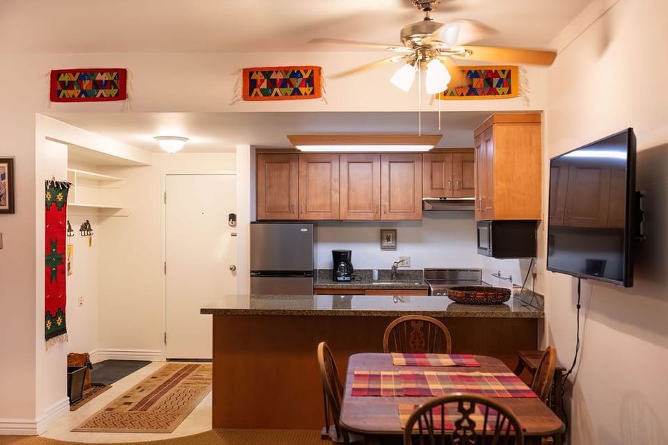 Stocked kitchen, dining room table and entryway.  Dining table seats 6