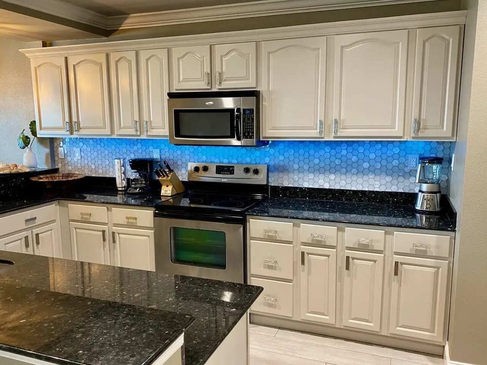 Under Cabinet Lighting Reflecting on the Tile Backsplash and Granite Counter Top