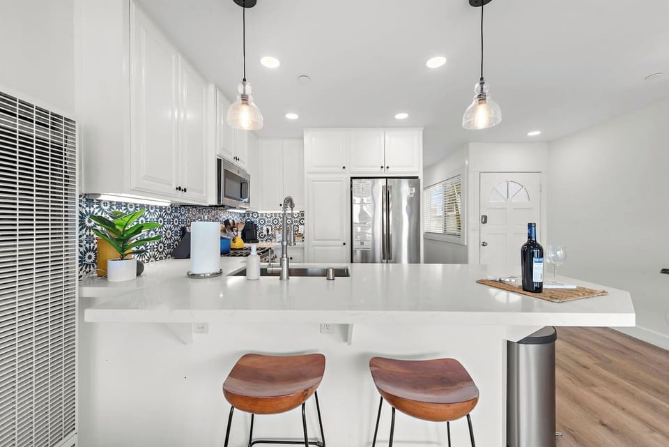 Breakfast bar is a great place to sit and chat with people in kitchen or living room