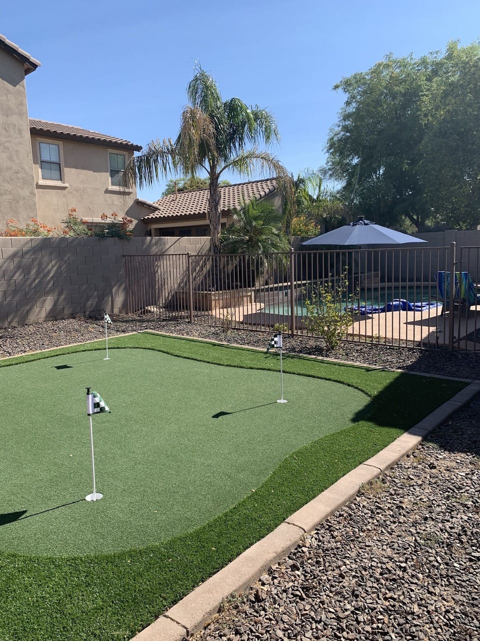 Putting green with 4 holes and perimeter rough for chipping.