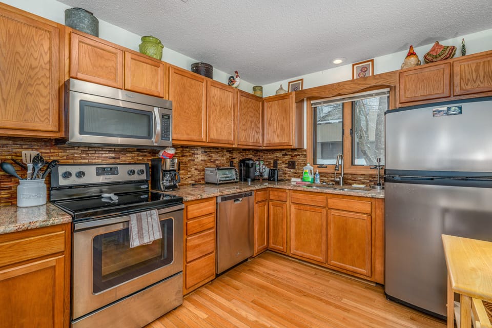 The fully equipped kitchen with granite countertops is ready for you.