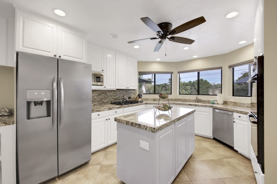 The fully-equipped kitchen features stunning stainless steel appliances.