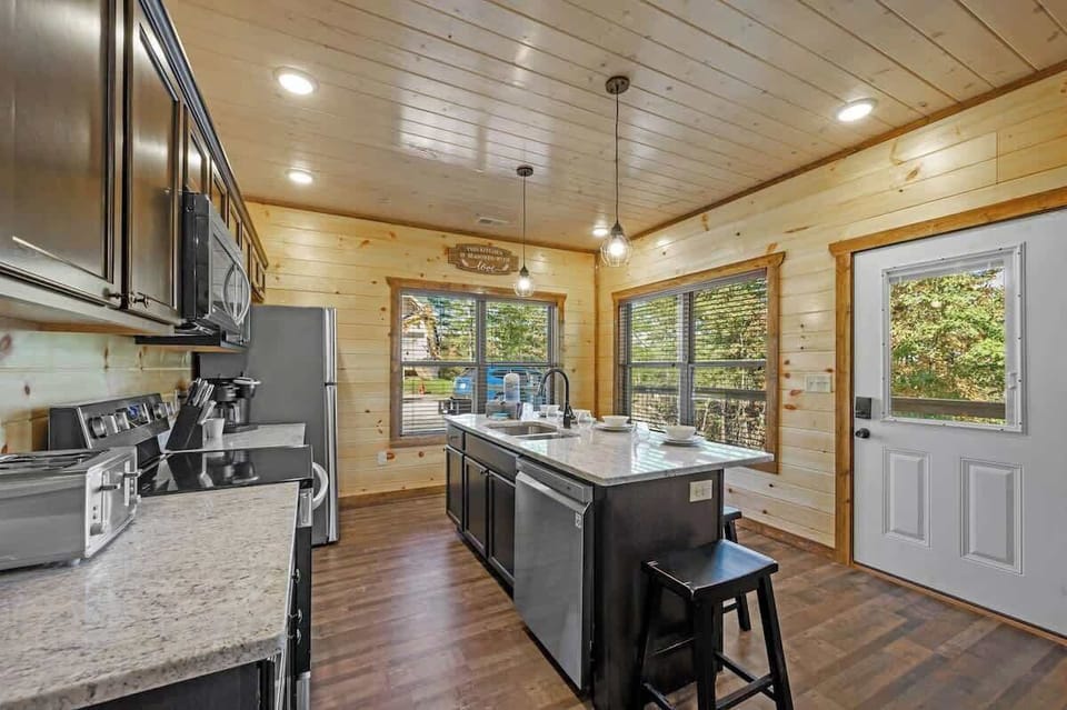Modern state of the art Fully functioning Kitchen and large granite countertop with seats