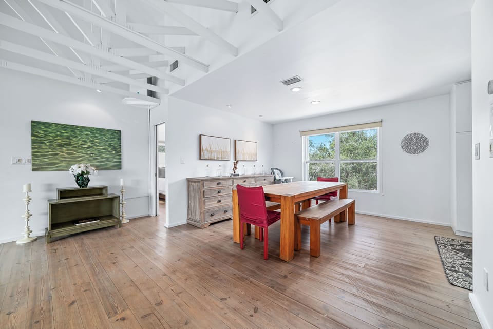 Rustic table with bench seating and bright windows for family meals!