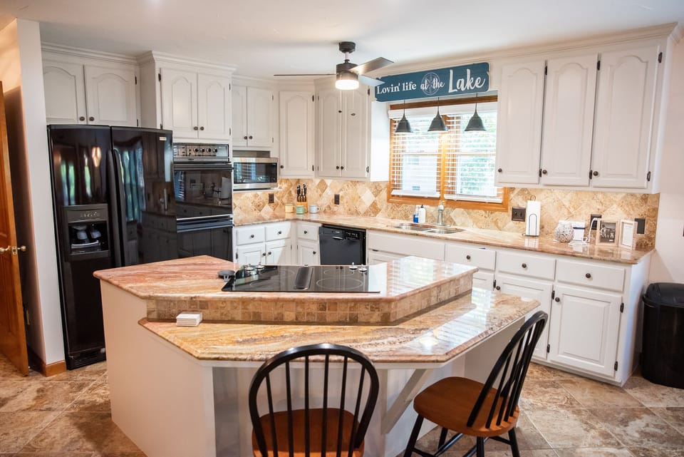 Kitchen with double ovens, dishwasher, and microwave