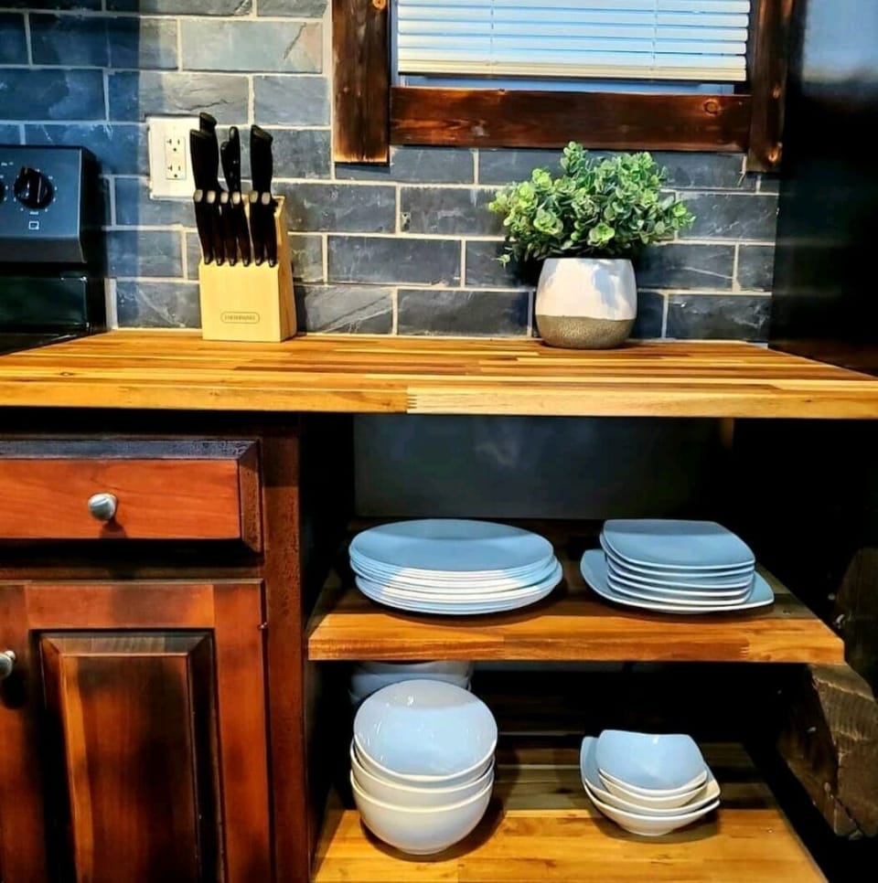 Stocked with dishes and utensils. 