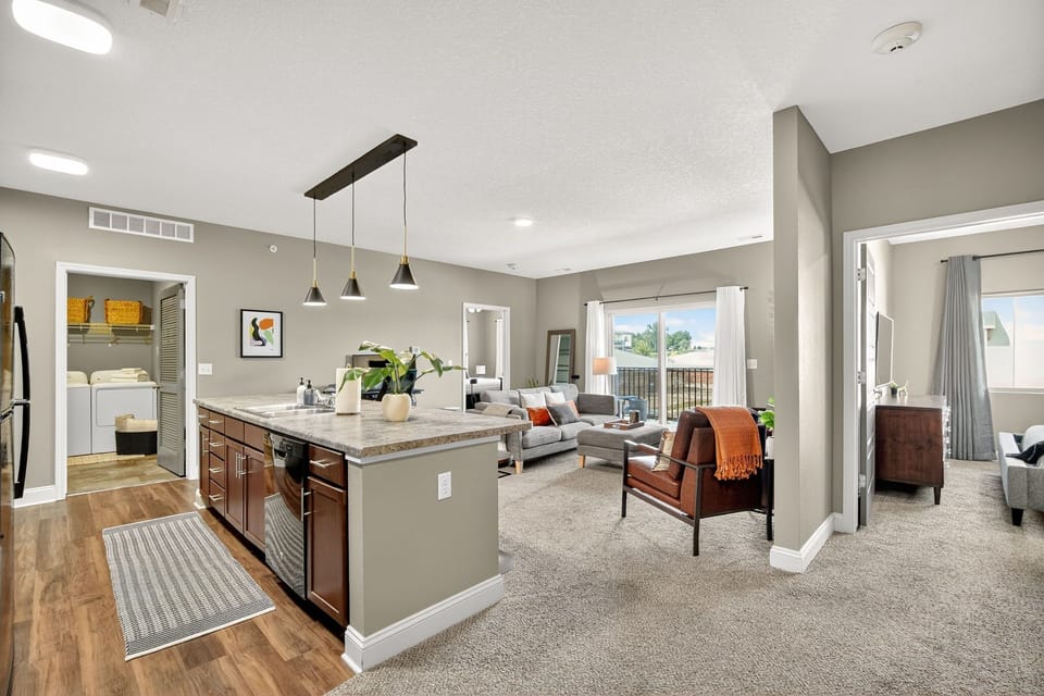Enjoy a spacious open-concept layout where the kitchen flows into a bright living room with balcony views. Modern lighting, updated finishes, and condo-inspired design details.