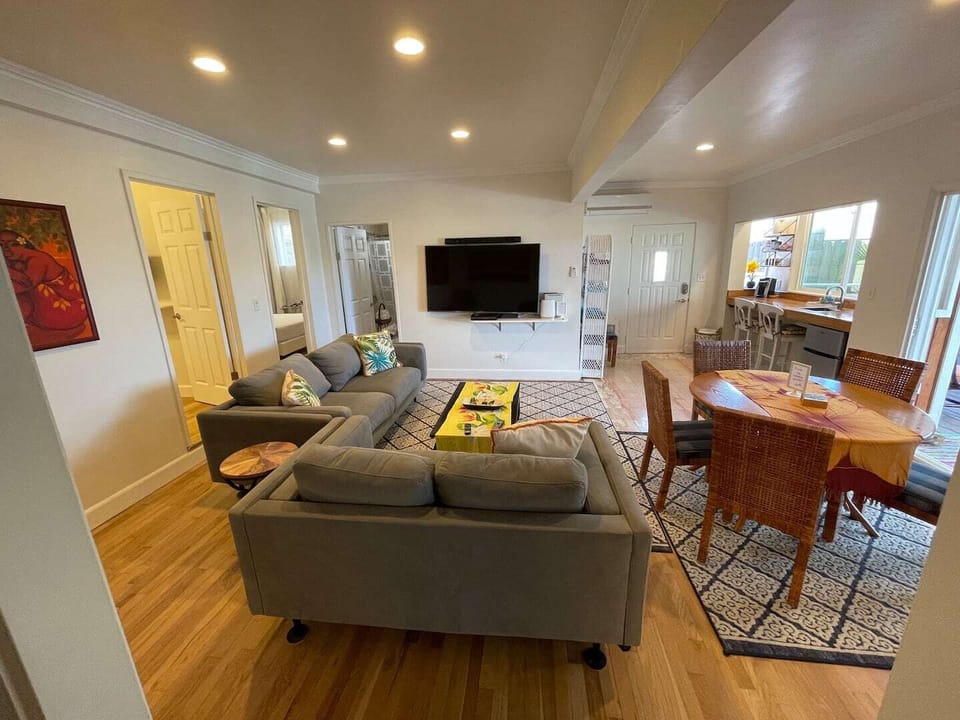 Downstairs living space sports a 65” tv, game table and coffee/wine bar