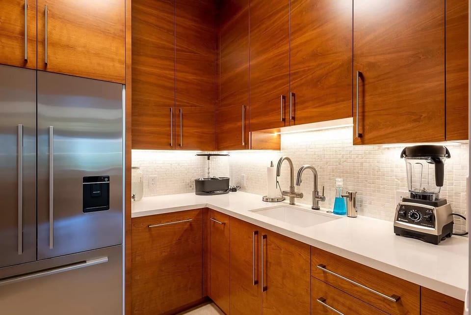 Chefs pantry with full fridge , sink and many other amenities between main kitchen and boot room