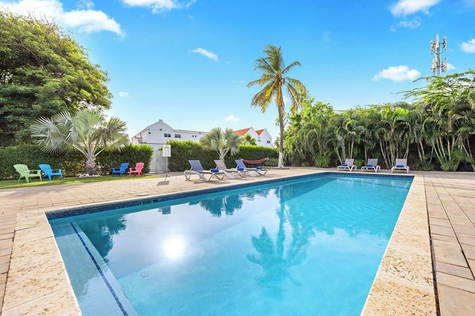 A sunny pool area with comfortable sun loungers, perfect for soaking up the sun and relaxing by the water