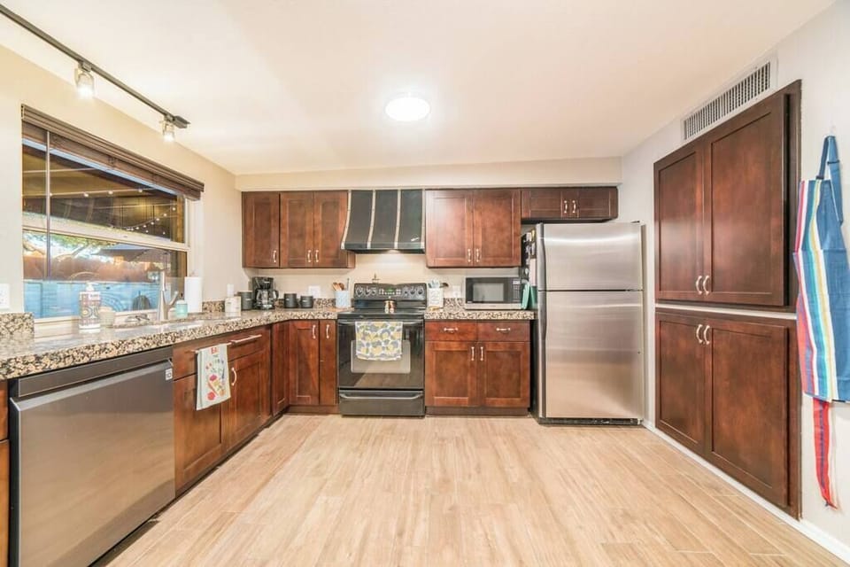 Stepping into sophistication with our rich and inviting dark wood-themed kitchen