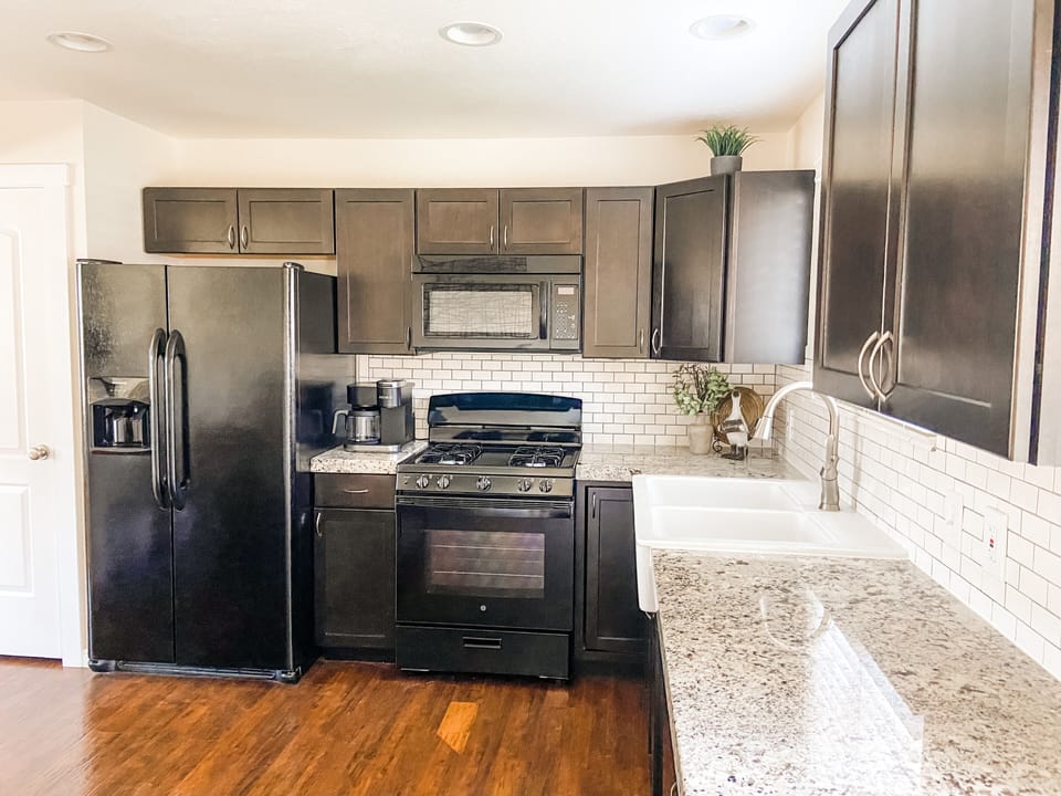 Full kitchen with a dishwasher, a GE gas stove, and lots of counter space