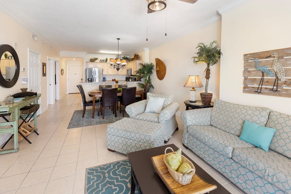 Sink into coastal comfort in your bright, open living space where turquoise accents and tropical touches create the perfect beach vacation atmosphere.