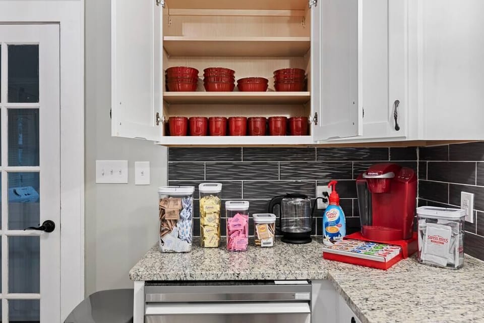 Coffee station is stocked with Keurig, coffee, tea, sugar, sugar substitutes, kettle, creamer and many more details. 