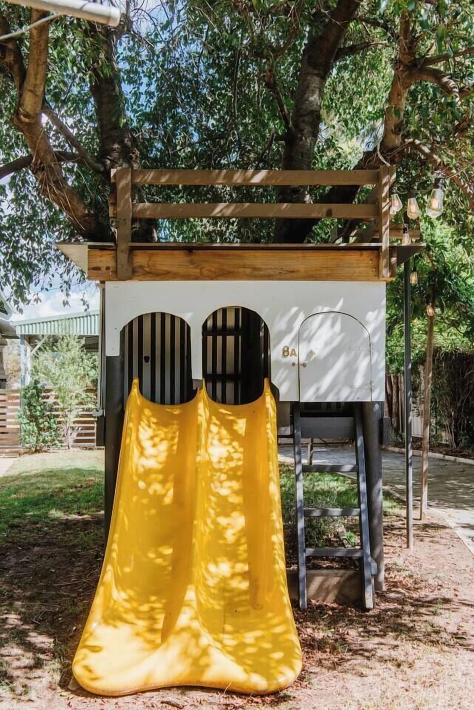 A playhouse with slides will keep the kids busy out in the backyard.