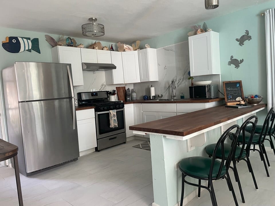 Kitchen with stainless steel fridge and gas stainless steel range/oven