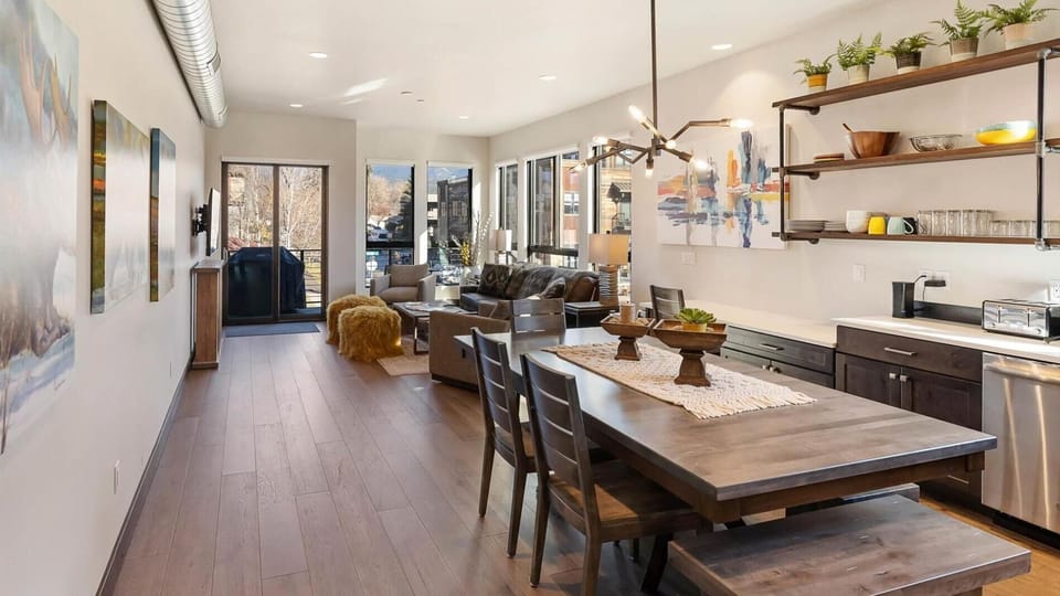 Open concept living room, dining area, and fully stocked kitchen. Living room includes luxury top of the line king sofa sleeper, balcony with gas grill