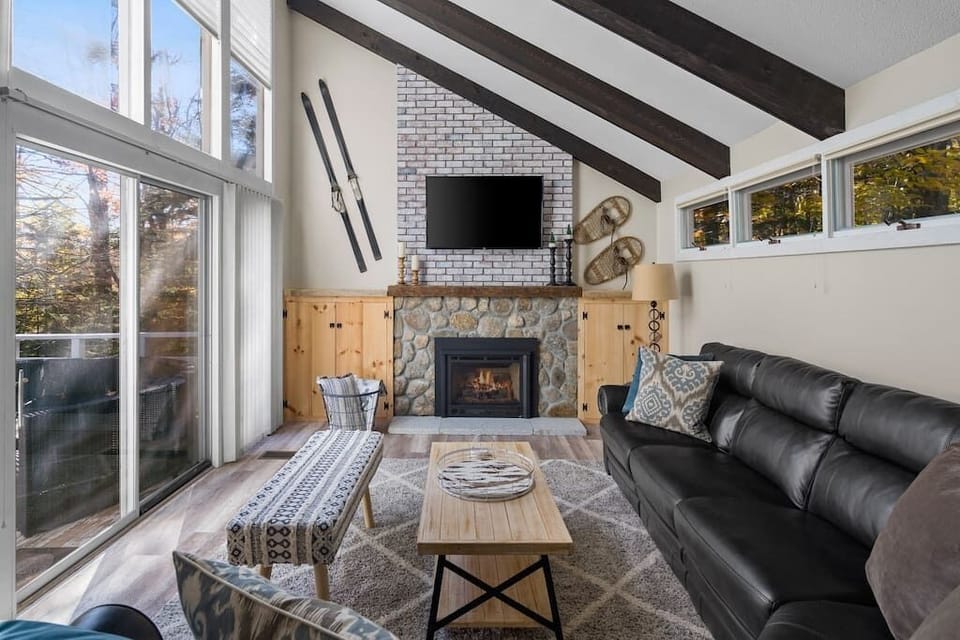 Spacious living room with gas fireplace and smart TV.