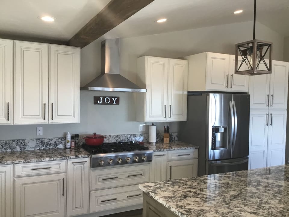 Large bright eat in kitchen with 6 burner gas stove. 