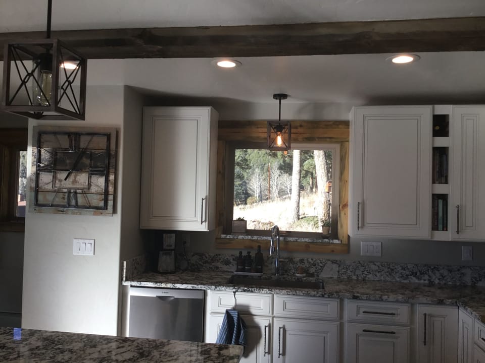 Front door on left and kitchen with view of garden and hot tub. 