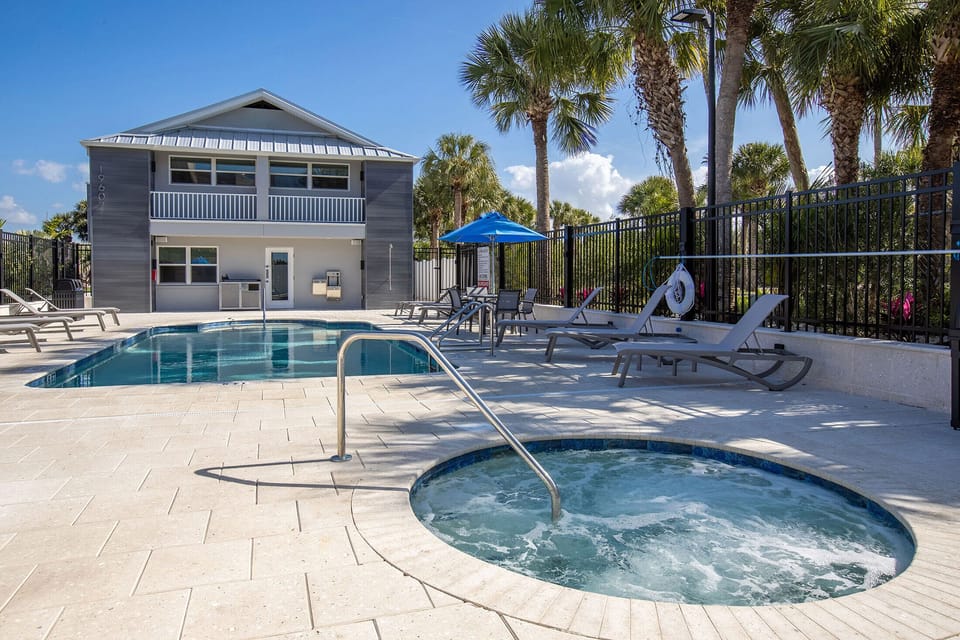 Soak in the bubbling hot tub beside the sunlit pool.