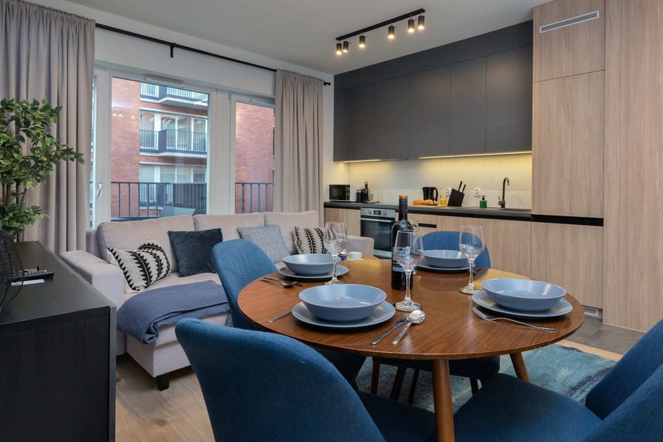 The spacious living room features a comfortable sofa bed and a flat-screen television.