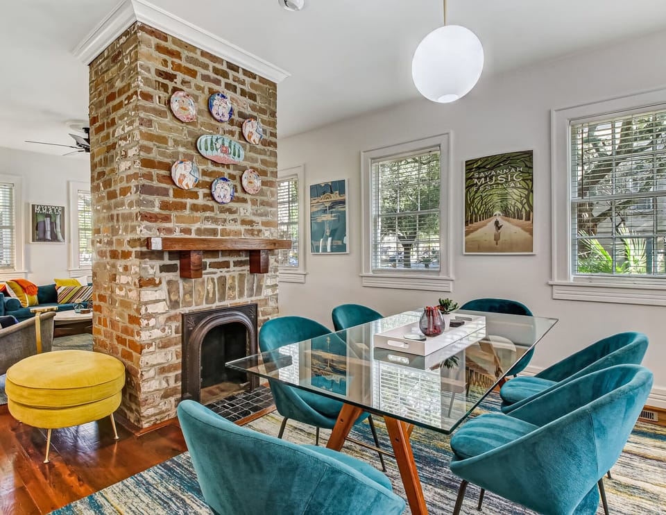 The dining area is located just on the other side of the decorative fireplace.