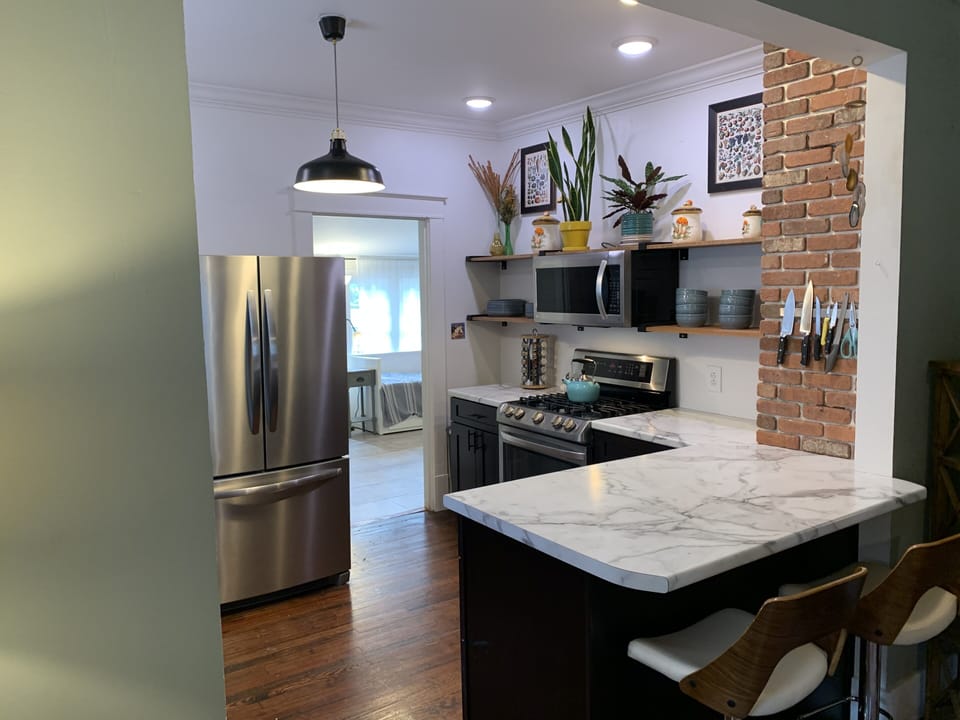 Remodeled Open Kitchen and Sun Room Behind.