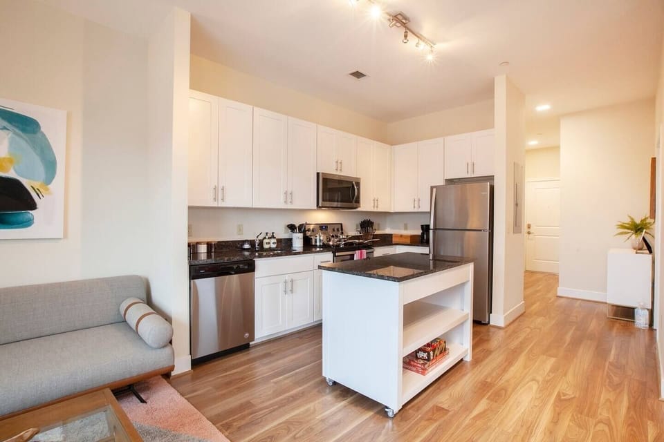 View into the kitchen and entryway from the living room area.