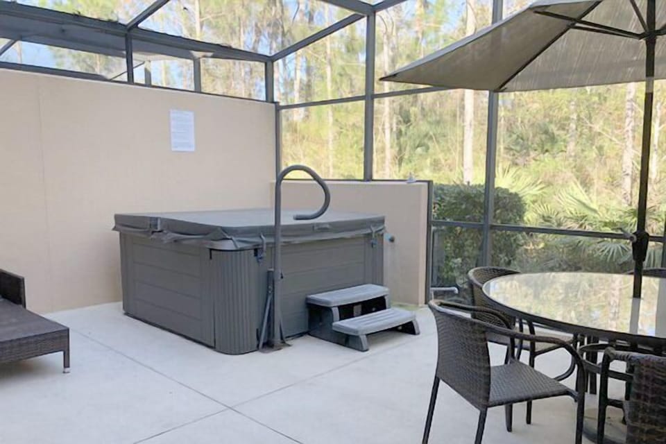 Private covered lanai with hot tub, dining area and lounge chairs