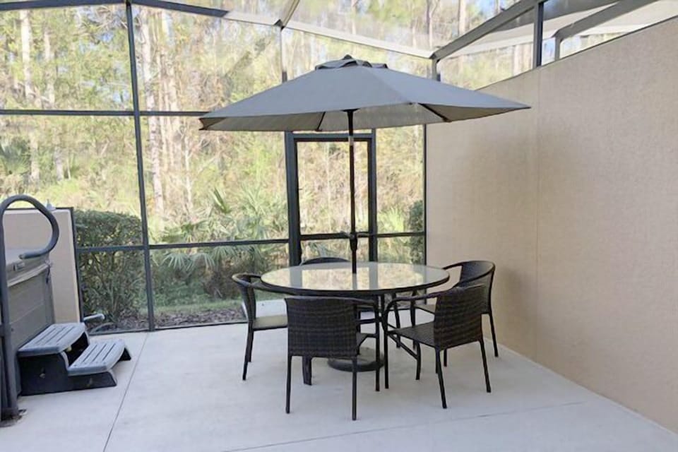 Private covered lanai with dining area
