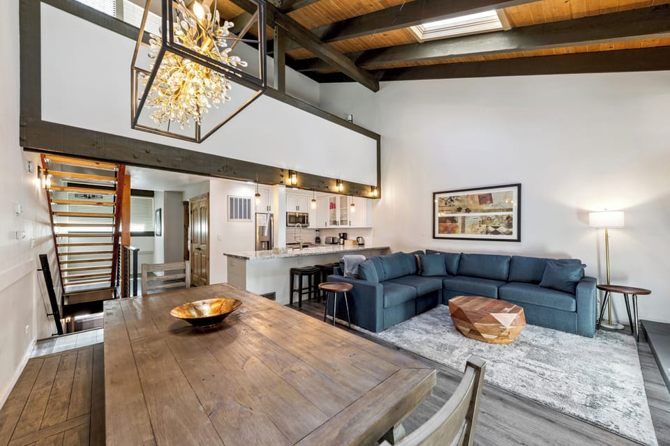 Unwind in your open-concept living space with soaring ceilings, natural light from skylights, and a cozy sectional perfect for gatherings. The modern kitchen awaits your culinary adventures.