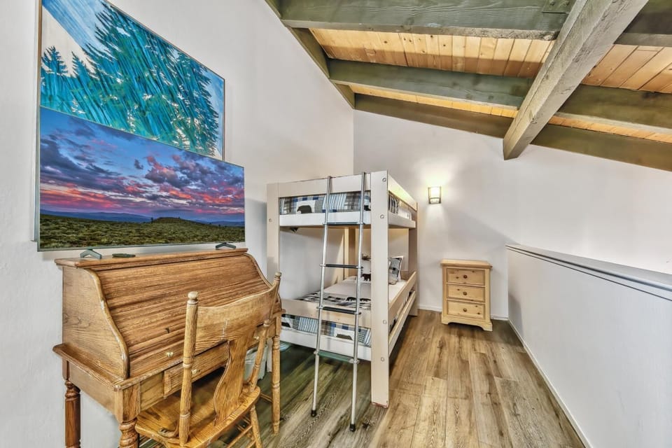 Loft with twin sized bunk beds and a desk. Perfect sleeping area for the kids.
