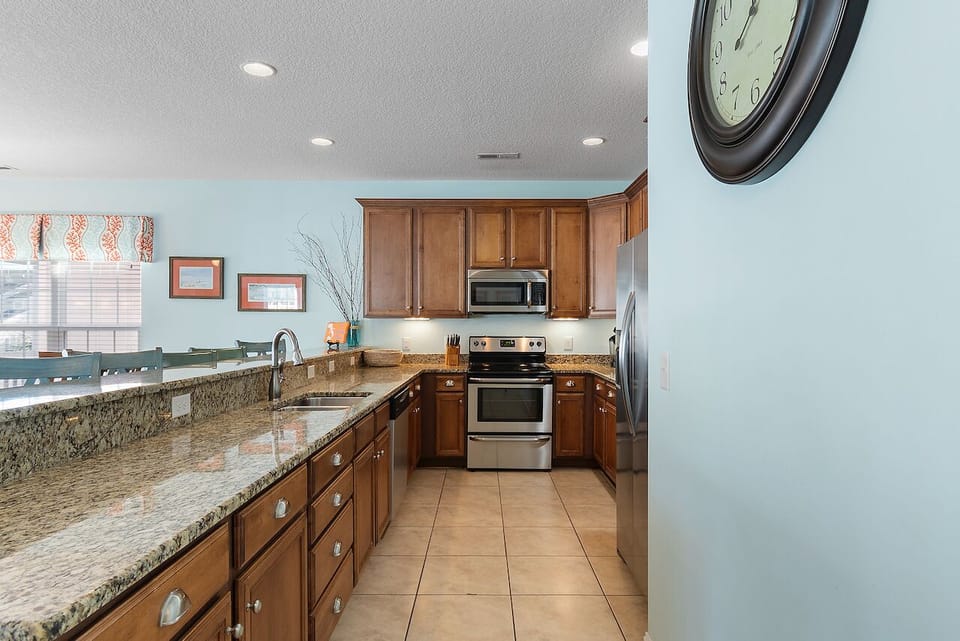 Your fully equipped kitchen features granite countertops, warm wood cabinets, and stainless steel appliances for creating memorable meals together.