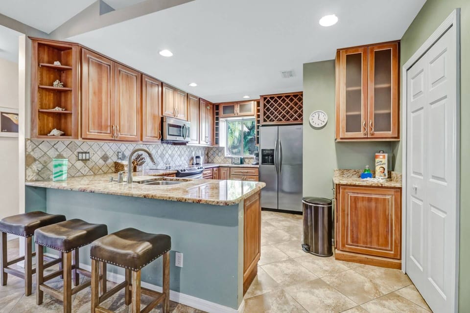 An eating bar with 3 bar stools creates a great spot to grab a quick bit to eat.