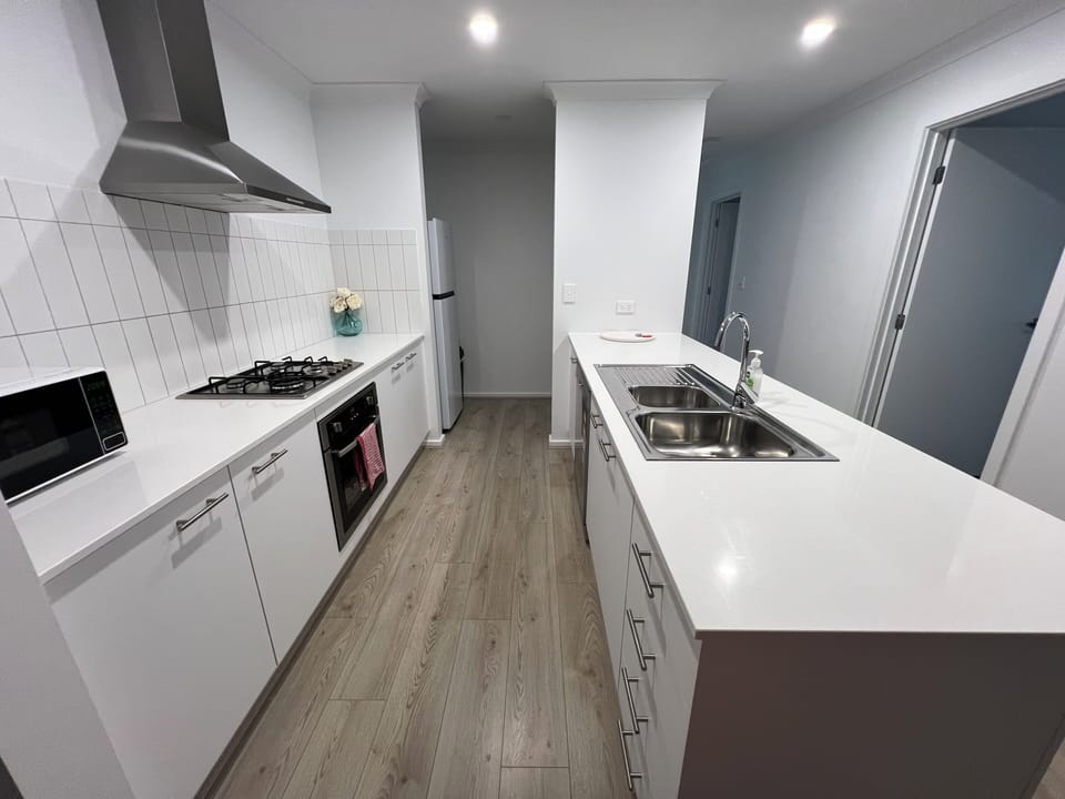 Kitchen with dishwasher, fridge, cooktop, oven, microwave
