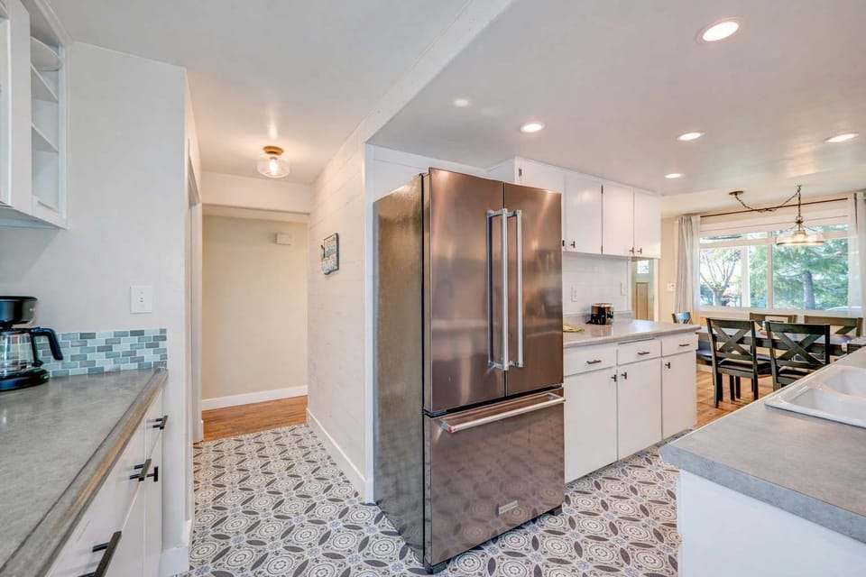 Fully equipped kitchen with modern appliances and an open flow into the dining space.