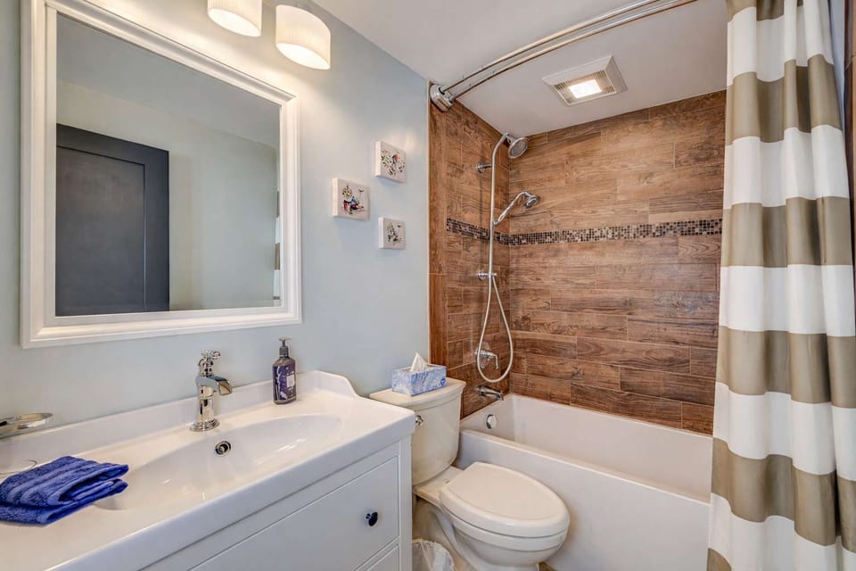 Clean and cozy bathroom with modern fixtures, bright lighting, and a relaxing shower for everyday comfort.