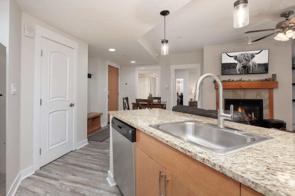 Your open kitchen flows seamlessly into the living area, where granite counters and stainless appliances make cooking effortless.