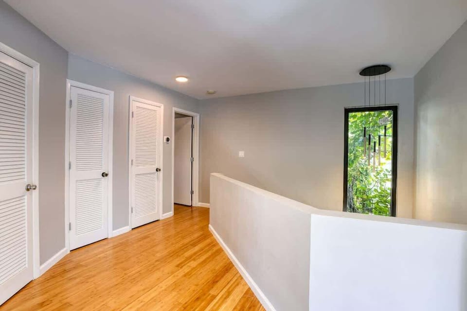 House 1: Upstairs landing with giant store front sized window