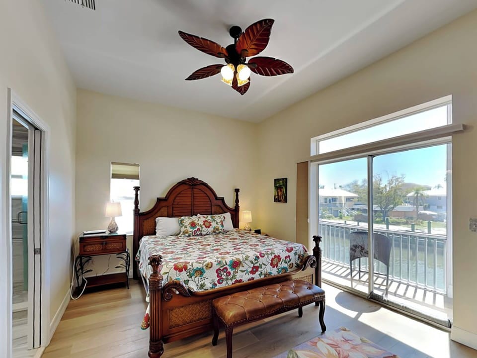 Primary Bedroom - King Bed, Private Balcony, TV + En Suite Bathroom - Second Floor