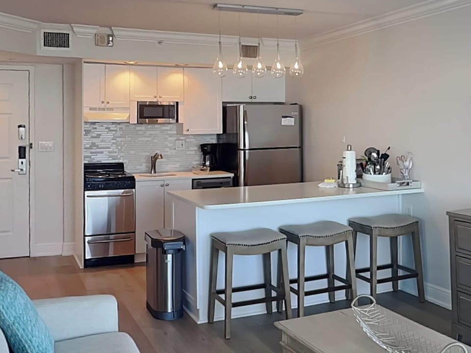 Fully Equipped Kitchen + Breakfast Bar Seating for Three