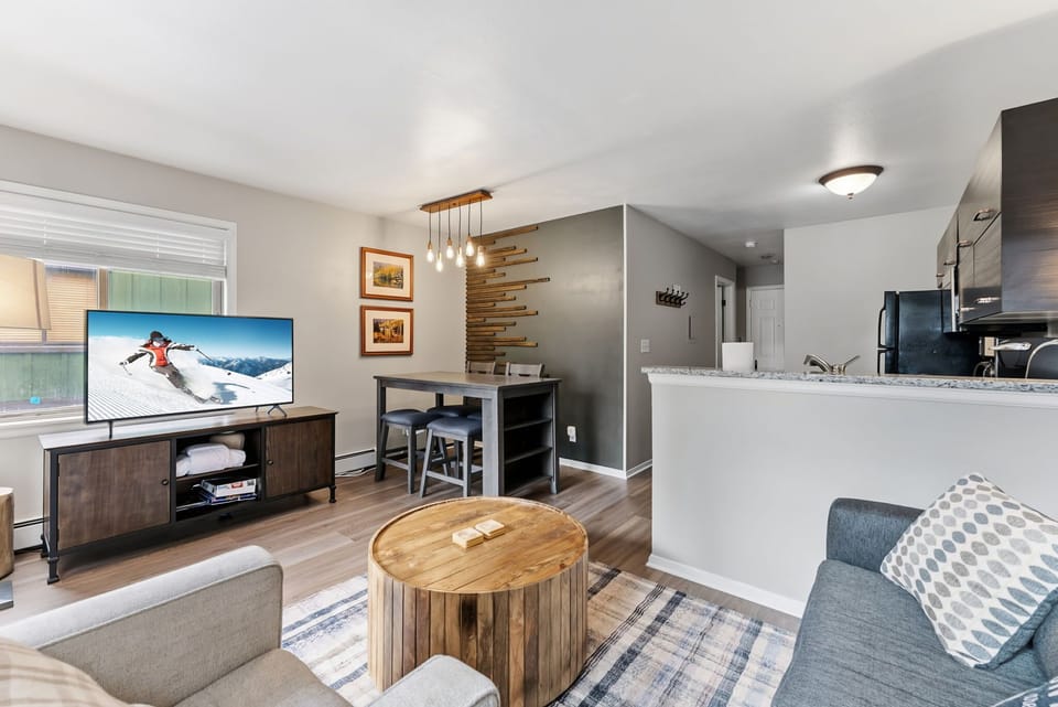Living Room: 55" Smart TV, comfortable seating, patio access